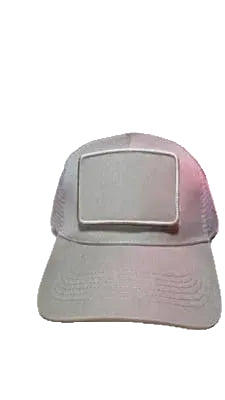 A light beige trucker-style cap with a rectangular patch on the front, resting on a light wood surface.
